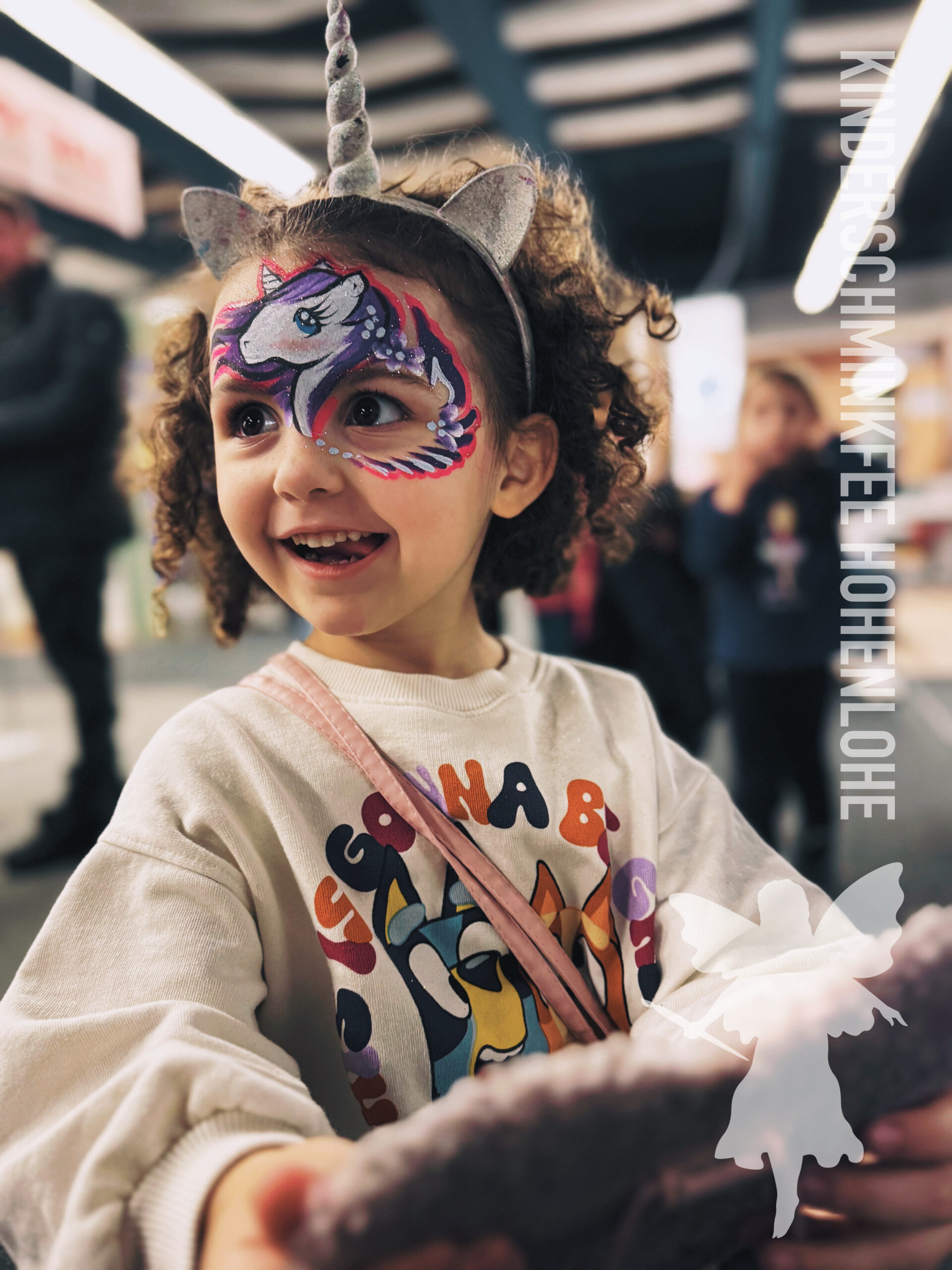 Ein Kind mit einem Einhorn im Gesicht beim Kinderschminken in Hohenlohe